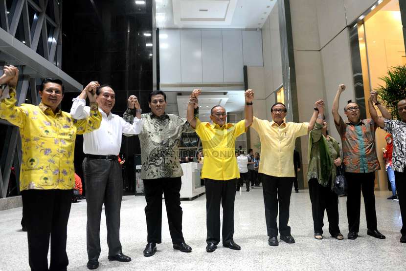  Ketua Umum Partai Golkar Aburizal Bakrie (tengah) bersama jajaran pengurus partai mengangkat tangan bersama usai menggelar konferensi pers terkait penyenggelaraan Munas ke-7 Partai Golkar di Jakarta, Selasa (25/11) malam. (Republika/WIhdan)