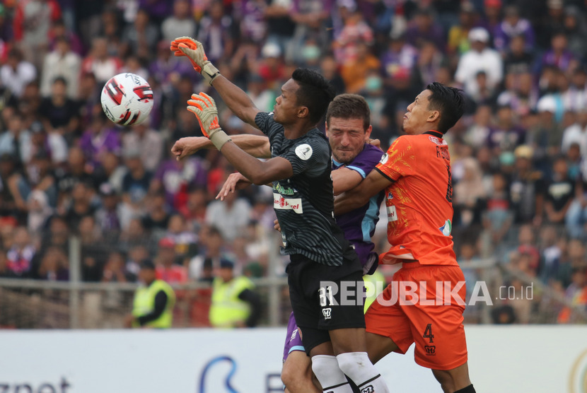 Kiper Persiraja Banda Aceh Fakrurrazi (kiri) mencoba menangkap bola dibayang-bayangi pesepak bola Persik Kediri Nikola Asceric (tengah) saat pertandingan Liga 1 2020 di stadion Brawijaya, Kota Kediri, Jawa Timur, Sabtu (14/3/2020).