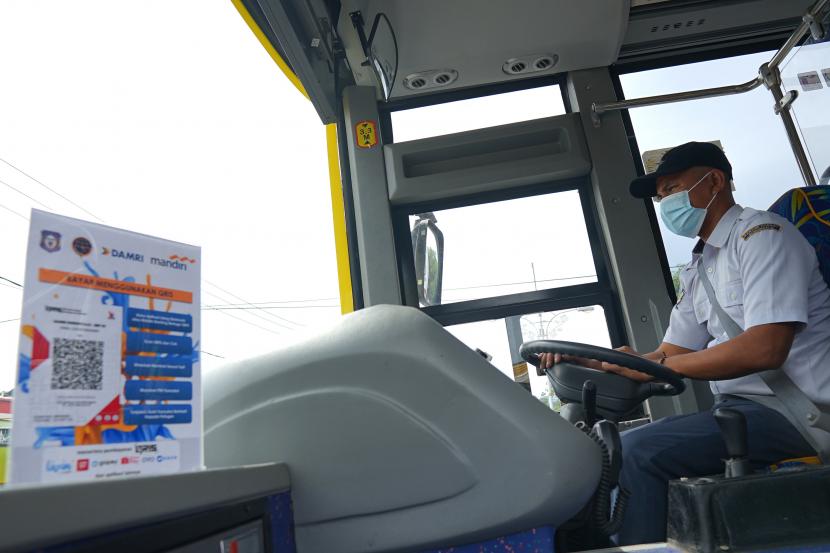 Kode pembayaran digital diletakkan di samping sopir bus Damri di kompleks Universitas Negeri Gorontalo (UNG) Kota Gorontalo, Gorontalo, Sabtu (4/12/2021). Bank Mandiri bekerja sama dengan Perum Damri dalam penerapan pembayaran nontunai Quick Response Code Indonesia Standart (QRIS) pada pembayaran jasa transportasi bus Damri di Gorontalo.