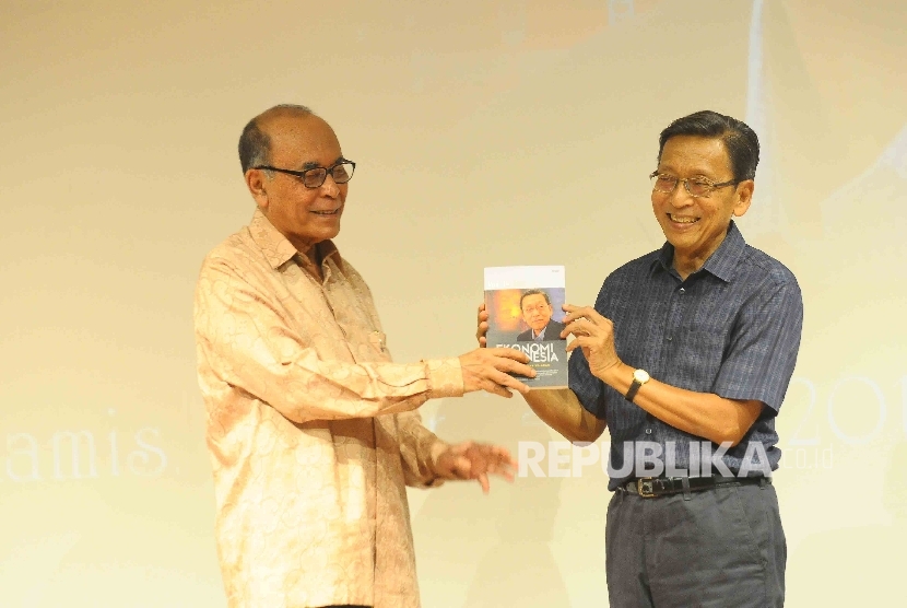 Komisaris Utama Kelompok Penerbit Mizan Abdillah Toha (kiri) memberikan buku 