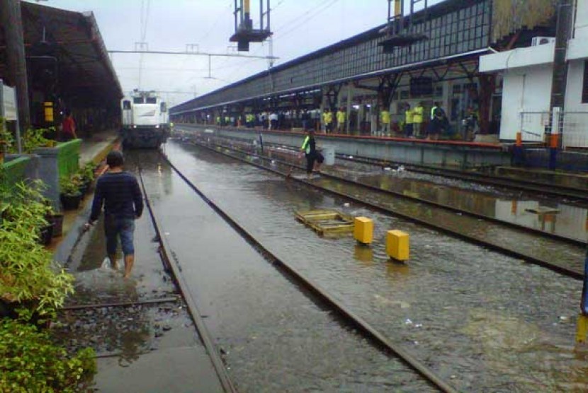 Air menggenangi rel kerta di Stasiun Tebet karena hujan yang mengguyur Jakarta sejak Kamis (18/2) siang. Akibatnya, terjadi antrean kereta rel listrik (KRL) yang hendak melintas di Stasiun Tebet.