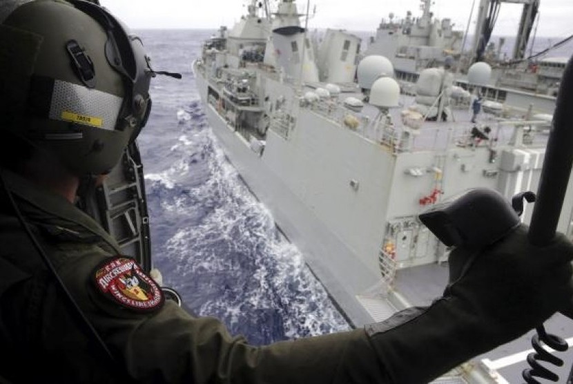 Leading Seaman Aircrewman Joel Young looks out from Tiger75, an S-70B-2 Seahawk helicopter, in the southern Indian Ocean for the missing Malaysian Airlines flight MH370. 