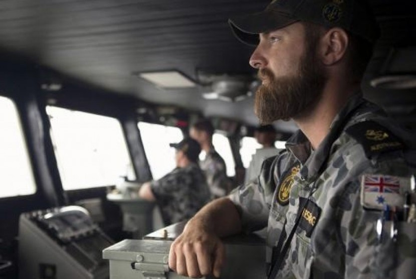 Leading Seaman Luke Horsburgh watches during his duty as Quartermaster on the bridge of the Australian Navy ship HMAS Success in the search area for missing Malaysian Airlines flight MH370. (Picture is released on March 23, 2014)