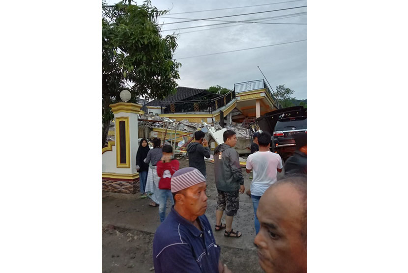 Lima orang terjebak di dalam rumah yang ambruk akibat gempa di Bengkel Rappang, Jl Monginsidi, Sulawesi Barat, Jumat (15/1). 