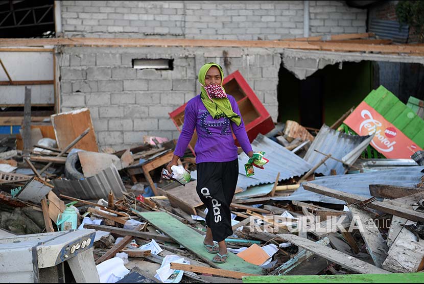 Lina berpose di depan rumahnya yang rusak akibat gempa dan tsunami di Lere, Palu, Sulawesi Tengah. (ilustrasi)