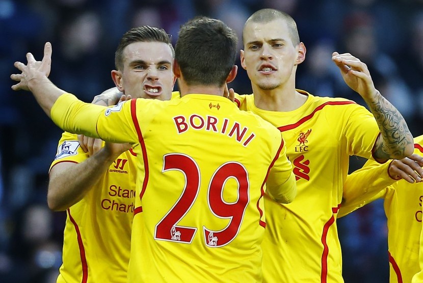 Liverpool's Fabio Borini celebrates his goal against Aston Villa with Jordan Henderson (L) and Martin Skrtel (R) during their English Premier League soccer match at Villa Park in Birmingham, central England, January 17, 2015.