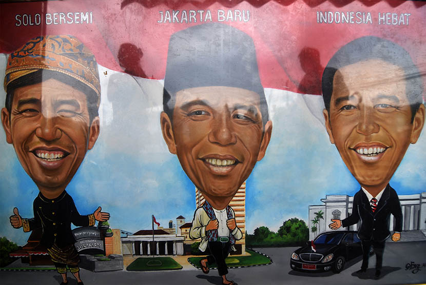 Lukisan karikatur Presiden Joko Widodo dijual di kios pelukis jalanan, Pasar baru, Jakarta, Selasa (27/1). 