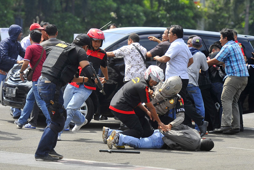   Petugas kepolisian menangkap massa yang berusaha merampas kotak suara usai pencoblosan ketika simulasi pengamanan tempat pemungutan suara (TPS) di Mapolda Metro Jaya Jakarta, Senin (7/4).  (Antara/Wahyu Putro)