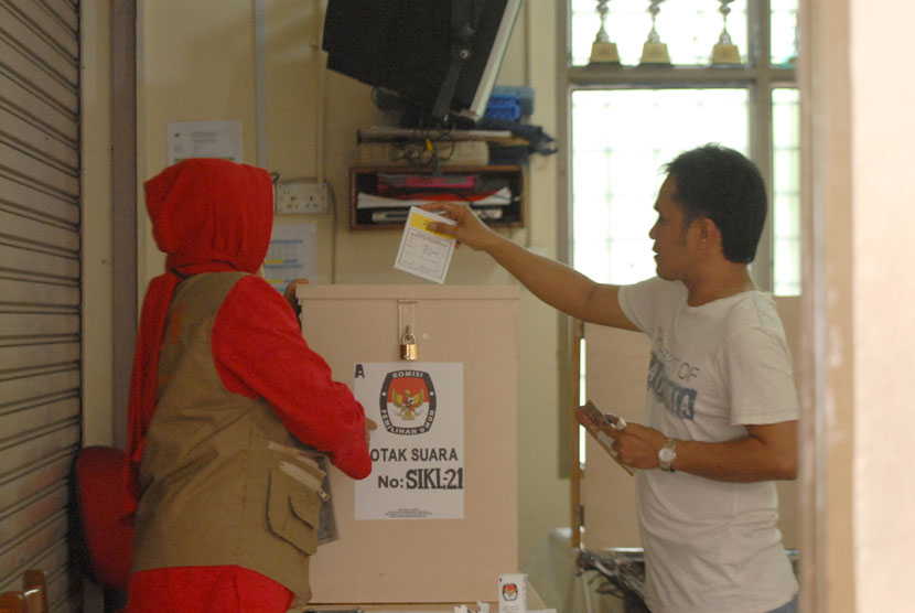 Seorang WNI yang menetap di Malaysia mencoblos di bilik suara dalam Pemilihan Legislatif yang dilaksanakan di Sekolah Indonesia Kuala Lumpur, Malaysia, Ahad (6/4).  (Antara/Rafiuddin Abdul Rahman)