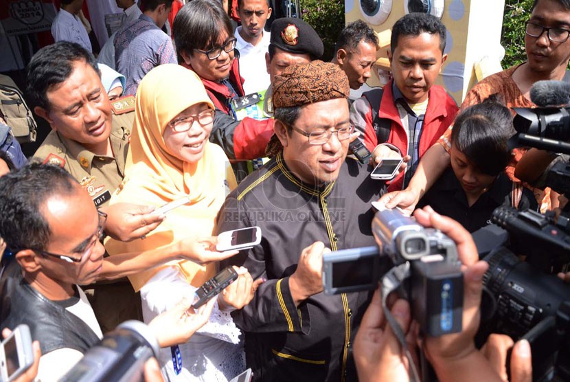  Gubernur Jabar, Ahmad Heryawan diwawancarai awak media usai melakukan pencoblosan di TPS 1 Keluarahan Babakan Ciamis, Kota Bandung, Rabu (9/4). (Republika/Edi Yusuf)