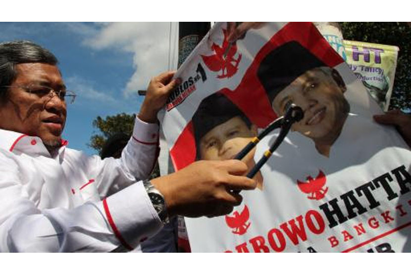 Gubernur Jawa Barat Ahmad Heryawan (Aher) menurunkan alat peraga kampanye Pemilu Presiden (pilpres) 2014 di kawasan Dago, Kota Bandung, Ahad (6/7).