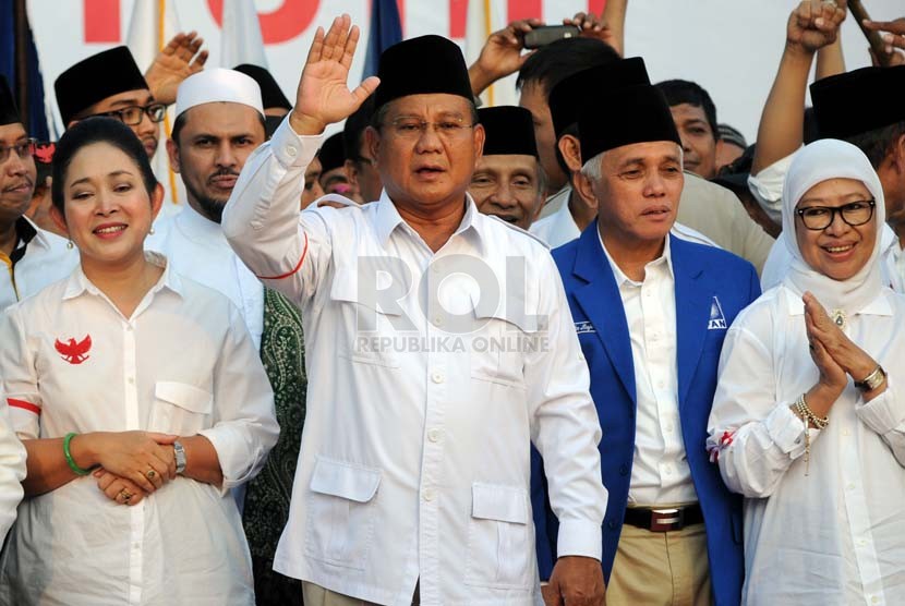  Capres nomor urut satu Prabowo Subianto (kedua kiri) didampingi mantan istrinya Titiek Soeharto (kiri) dan cawapres Hatta Rajasa (kedua kanan) menyapa pendukungnya di Pelataran Tugu Proklamasi, Jakarta, Senin (14/7). (Republika/Aditya Pradana Putra)