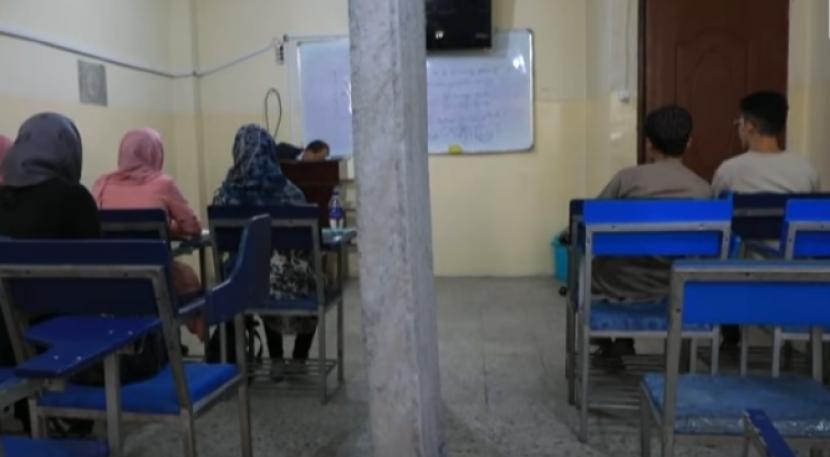Mahasiswa dan mahasiswa Afghanistan duduk belajar terpisah.