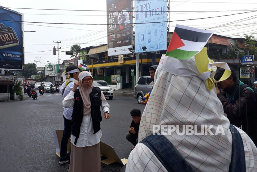 Mahasiswa penyandang disabilitas Universitas Brawijaya (UB) menyampaikan pesan bela Palestinanya di Jalan Veteran Malang, Jumat (15/12). 