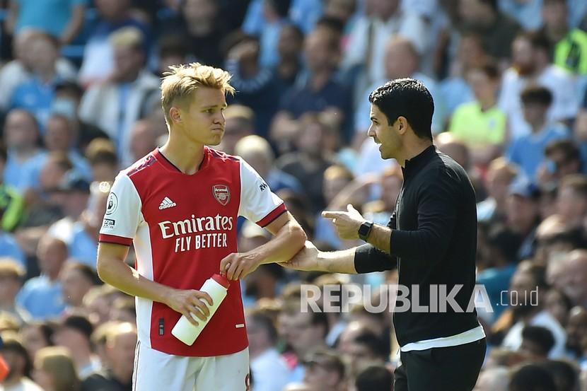 Manajer Arsenal Mikel Arteta berbicara kepada Martin Odegaard pada pertandingan sepak bola Liga Inggris antara Manchester City dan Arsenal di stadion Etihad di Manchester, Inggris, Sabtu (28/8). 