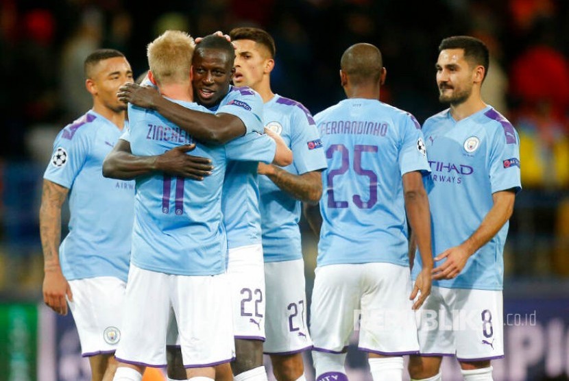 Manchester City players greet each other after the Group C Champions League soccer match between Manchester City and FC Shakhtar Donetsk in Kharkiv, Ukraine, Wednesday, Sept. 18, 2019. City won the match 3-0.