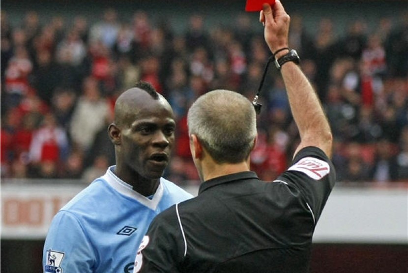 Mario Balotelli (kiri), striker Manchester City, diganjar kartu merah oleh wasit Martin Atkinson saat laga lawan Arsenal di Stadion Emirates, London, Ahad (8/4).