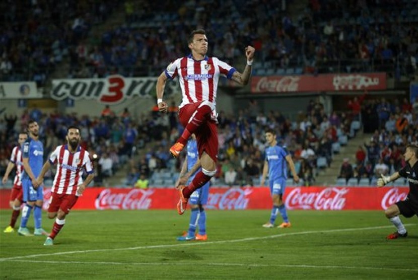 Mario Mandzukic merayakan golnya ke gawang Getafe, Senin (27/10).