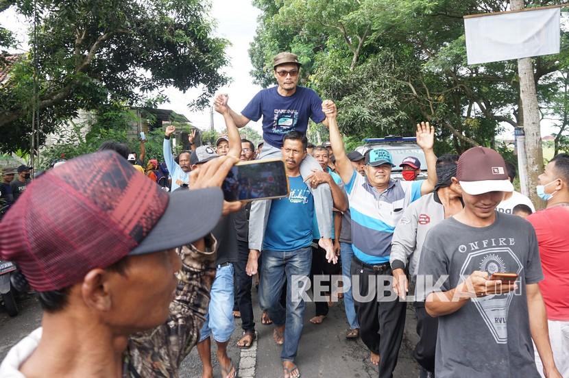 Massa pendukung memanggul calon kepala desa peraih suara terbanyak dalam gelaran pikades serentak di Desa Waung, Tulungagung, Jawa Timur, Selasa (30/11/2021). Pilkades serentak di 14 desa 11 kecamatan di Kabupaten Tulungagung itu diikuti 35 calon kepala desa, empat diantaranya merupakan pasangan suami-istri. 