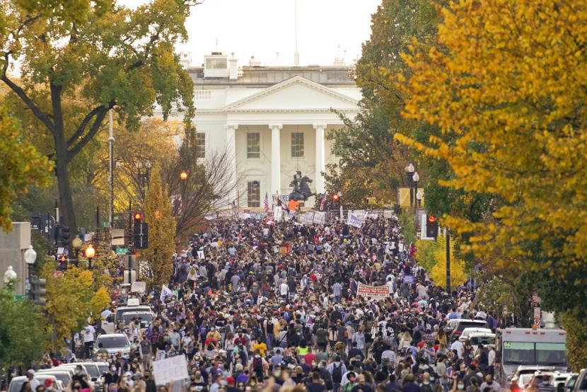 Masyarakat berkumpul di depan Gedung Putih merayakan terpilihnya Joe Biden dan Kamala Harris, Ahad (8/11). Kemenangan Biden muncul setelah tiga hari penghitungan suara yang penuh ketidakpastian. 