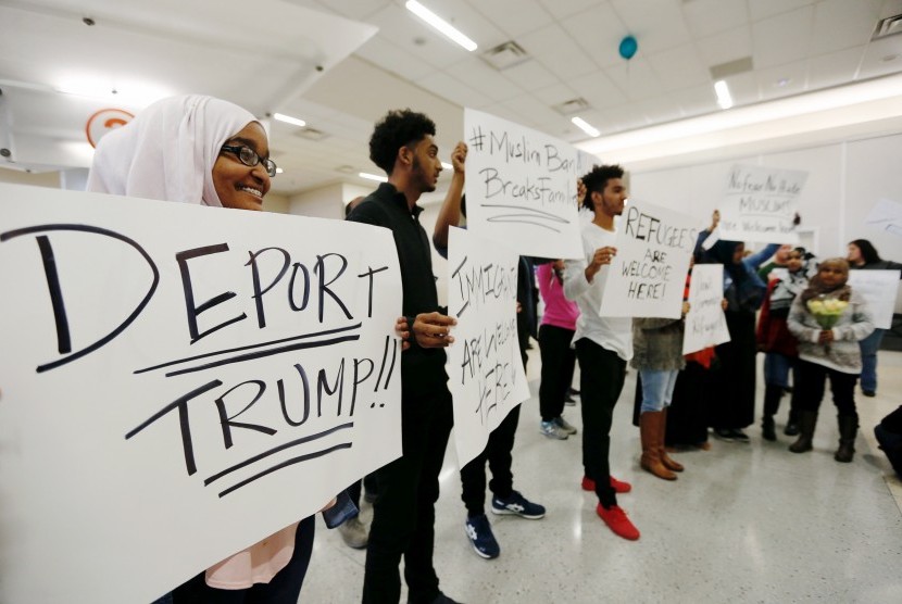 Masyarakat berunjuk rasa menentang kebijakan Donald Trump yang melarang sejumlah imigran Muslim masuk AS di Bandara Dallas, (29/1).