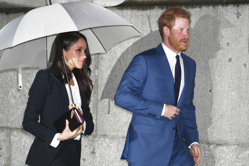 Meghan Markle mengenas setelan jas saat mendampingi Pangeran Harry di acara resmi, Kamis (1/2).