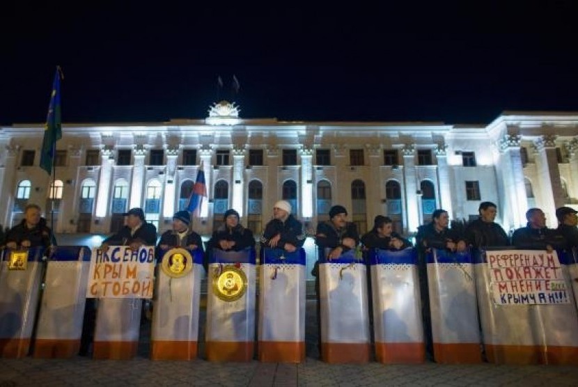 Members of Crimean self-defence units stand guard in front of the local government headquarters in Simferopol March 2, 2014.