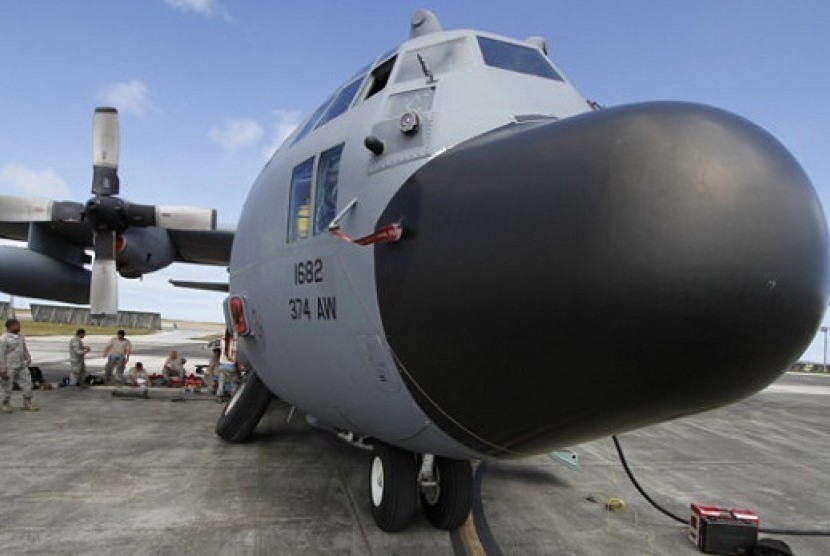 Members of the 374th Airlift Wing of US Air Force work on a C-130 aircraft during the Cope North military exercises at Andersen US Air Force Base in Guam Thursday, Feb. 7, 2013. 