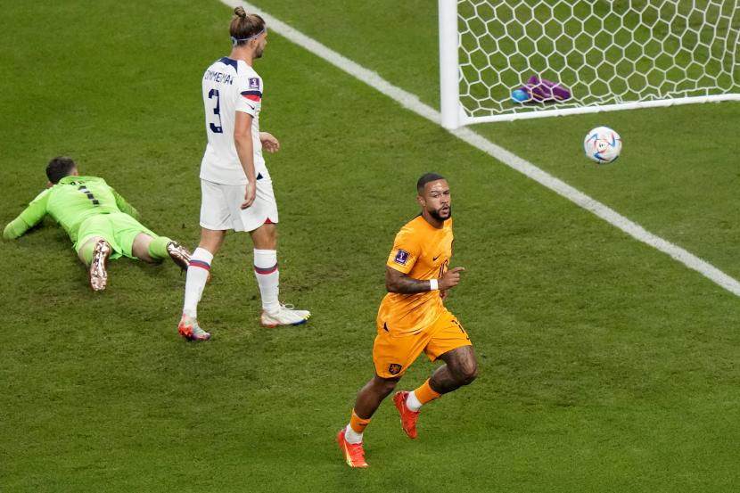 Memphis Depay dari Belanda, kanan, merayakan setelah mencetak gol pembuka pada pertandingan sepak bola babak 16 besar Piala Dunia 2022 antara Belanda dan Amerika Serikat, di Stadion Internasional Khalifa di Doha, Qatar, Sabtu, 3 Desember 2022. 