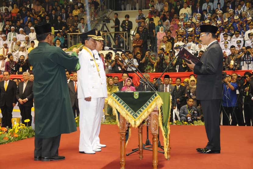 Mendagri Gamawan Fauzi (kanan) mengambil sumpah Gubernur Riau terpilih Annas Maamun (kedua kiri) dan wakilnya Arsyadjuliandi Rahman (ketiga kiri) pada pelantkan Gubernur Riau di Pekanbaru, Rabu (19/2). 