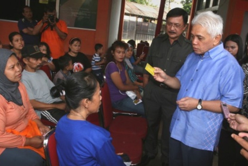 Menko Perekonomian Hatta Rajasa (kanan) berdialog dengan warga saat penyerahan Bantuan Langsung Sementara (BLSM) di Kantor Pos Mampang, Jakarta, Sabtu (22/6)