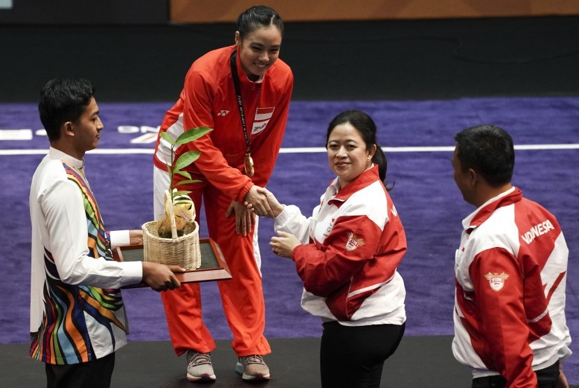 Menko PMK Puan Maharani (kedua kanan) disaksikan Menpora Imam Nahrawi (kanan) menyerahkan medali kepada atlet wushu Indonesia Lindswell Kwok ketika upacara penyerahan medali wushu nomor Taijijian putri di KLCC, Kuala Lumpur, Malaysia, Senin (21/8). 