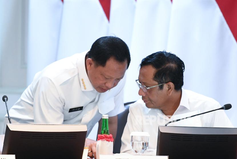 Menko Polhukam Mahfud MD (kanan) berbincang dengan Mendagri Tito Karnavian sebelum mengikuti rapat kabinet terbatas di Kantor Presiden Jakarta.