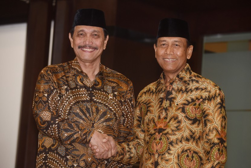 Menko Polhukam Wiranto (kanan) berjabat tangan dengan Luhut B. Pandjaitan ketika serah terima jabatan (sertijab) Menko Polhukam di kantor Kemenko Polhukam, Jakarta, Kamis (28/7). 