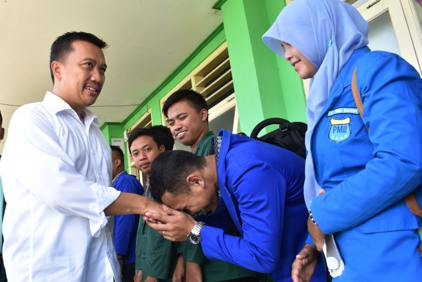 Menpora Imam Nahrawi (kiri) menyalami mahasiswa setelah menyampaikan kuliah umum di Kampus Institut Agama Islam Ngawi, Jawa Timur, Minggu (19/3).