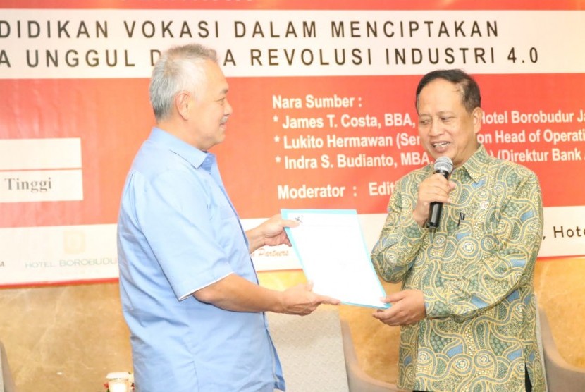 Menristekdikti Mohamad Nasir (kanan) menyerahkan SK perubahan bentuk JIHS menjadi Politeknik Jakarta Internasional kepada pendiri AGG Tomy Winata di Hotel Borobudur Jakarta, Jumat (4/10).