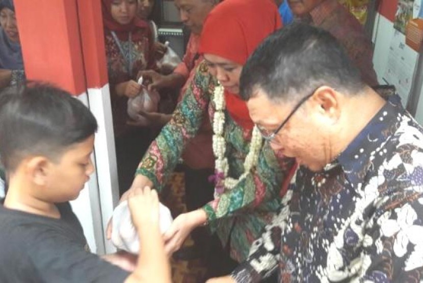 Mensos Khofifah Indar Parawansa membagikan telur untuk anak-anak di sela-sela persemian e-warong di Ngajuk, Ahad (9/4)