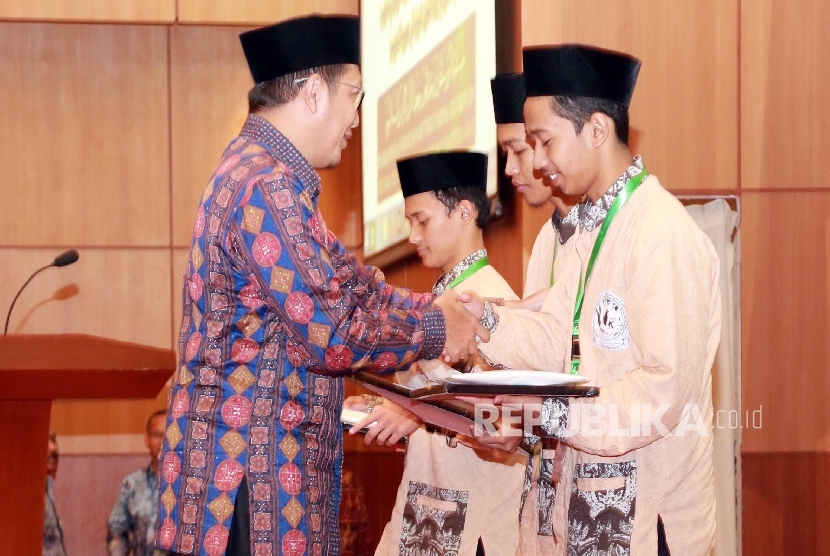 Menteri Agama Lukman Hakim (kiri) Saifuddin menyerahkan hadiah kepada pemenang Musabaqah Hafalan Hadis Nabawi, pada acara Penyerahan Hadiah Musabaqah Hafalan Alquran dan hadis Pangeran Sultan Bin Abdul Aziz Suud  (Ilustrasi)