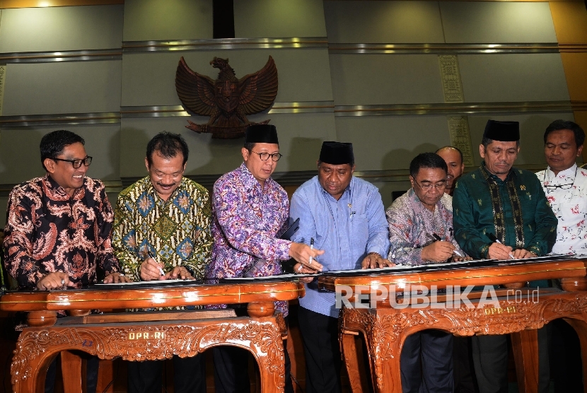  Menag Lukman Hakim Saifuddin (ketiga kiri), bersama Ketua Komisi VIII DPR Ali Taher Parasong (empat dari kanan), saat penetapan Biaya Penyelenggaraan Ibadah Haji (BPIH) di Kompleks Parlemen, Senayan, Jakarta, Jumat (24/3).