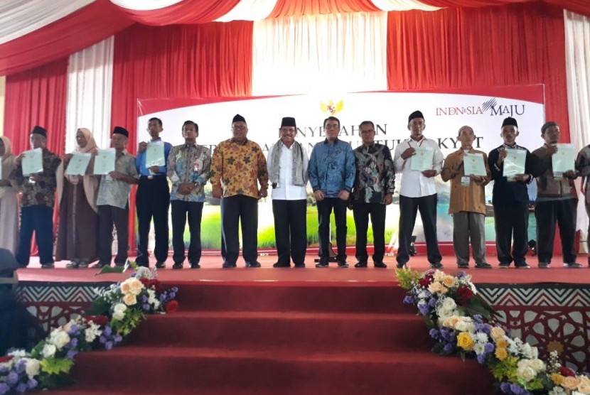 Menteri Agraria dan Tata Ruang (ATR)/Kepala Badan Pertanahan Nasional (BPN) Sofyan A Djalil menyerahkan sertifikat tanah untuk rakyat program reforma agraria melalui kegiatan redistribusi tanah di Ponpes Modern Assalam Kecamatan Warungkiara, Kabupaten Sukabumi, Jawa Barat, Jumat (7/2).