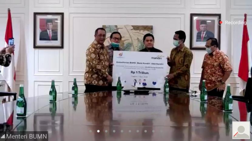 Menteri BUMN Erick Thohir menyaksikan pemberian asuransi secara simbolis dilakukan oleh Direktur Utama Bank Mandiri Royke Tumilaar kepada Ketua Umum Ikatan Dokter Indonesia (IDI) Dr. Daeng M Faqih di Jakarta, Rabu (1/4).