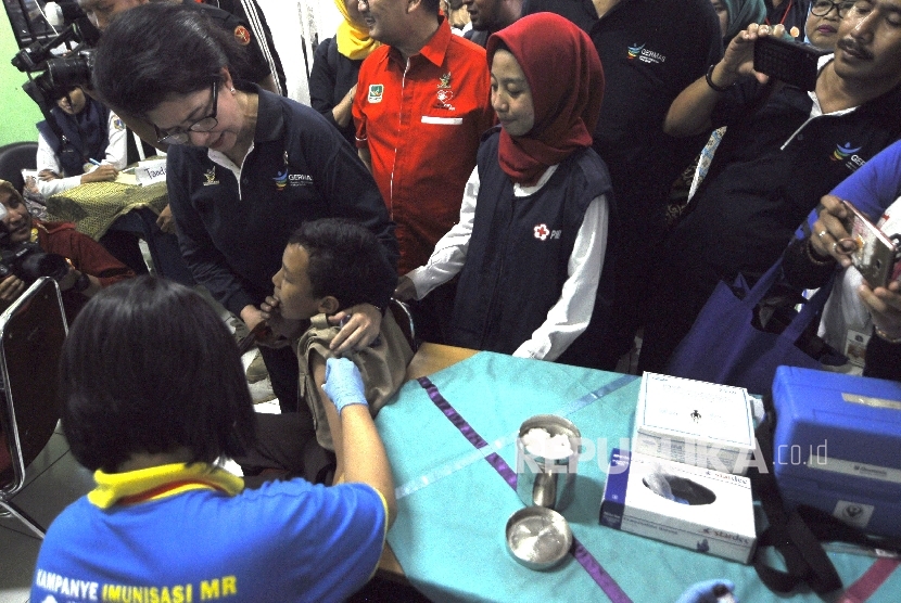 Menteri Kesehatan Nila F Moeloek menyaksikan seorang siswa diberikan suntikan imunisasi Measleas Rubela (MR) pada acara Kampanye Measles Rubella (MR) dan Campak sekaligus Peringati Asean Dengeu Day 2017 di SMPN 103 Cijantung, Jakarta, Rabu (2/7).