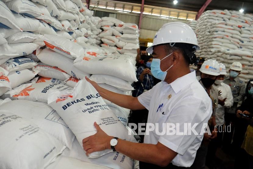 Muhadjir Effendy (tengah) melihat karung berisi beras saat meninjau gudang beras Bulog, di Medan