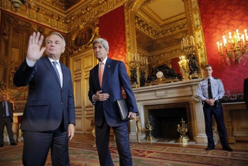 Menteri Luar Negeri Prancis Jean-Marc Ayrault (kiri) dan Menlu AS John Kerry berbicara pada wartawan sebelum pertemuan membahas konflik Suriah di Paris, Senin, 9 Mei 2016.