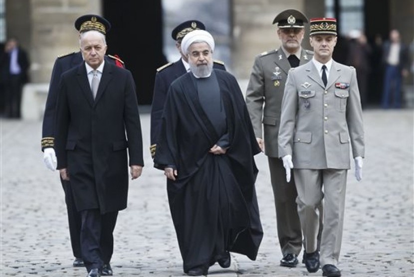 Menteri Luar Negeri Prancis Laurent Fabius (kiri) dan Presiden Iran Hassan Rouhani tiba untuk upacara penyambutan di Invalides, Paris, Kamis, 28 Januari 2016.