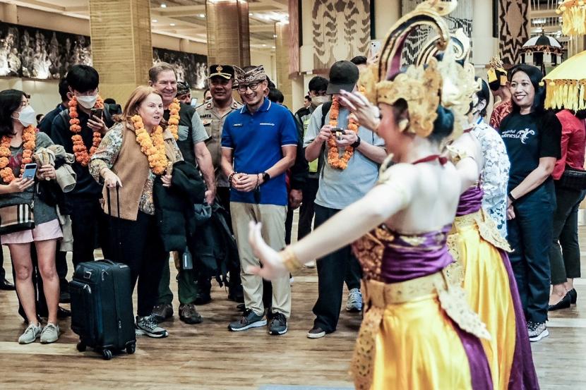 Menteri Pariwisata dan Ekonomi Kreatif, Sandiaga Salahuddin Uno saat menyambut kedatangan wisatawan mancanegara asal Toronto  di Bandara I Gusti Ngurah Rai, Bali pada Ahad (1/1/2023) dini hari.
