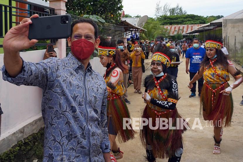 Menteri Pendidikan dan Kebudayaan Nadiem Makarim berswafoto dengan sejumlah penari di Sanggar Seni Nani Bili Kota Sorong, Papua Barat, Rabu (10/2/2021). Kunjungan kerja Mendikbud selama tiga hari di Papua Barat untuk mengetahui secara langsung permasalahan pendidikan dan kebudayaan di wilayah tersebut. 