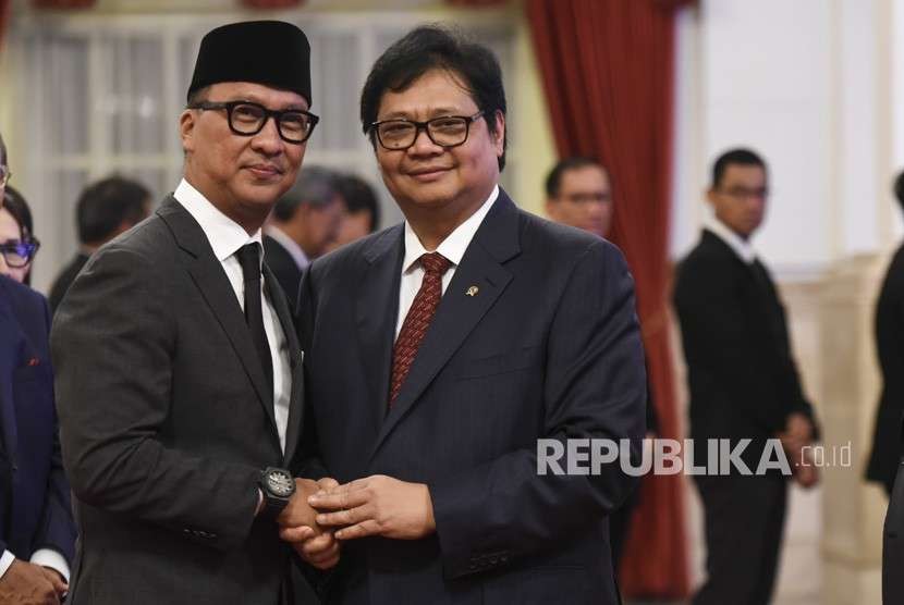 Menteri Perindustrian Airlangga Hartarto (kanan) memberikan ucapan selamat kepada Menteri Sosial Agus Gumiwang Kartasasmita (kiri) saat acara pelantikan di Istana Negara, Jakarta, Jumat (24/8).