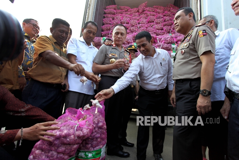  Menteri Pertanian Amran Sulaiman bersama dengan Kementerian Perdagangan dan Polri menyambut 2 kontainer bawang putih yang diimpor langsung dari China pada Operasi Pasar Bawang Putih di Pasar Induk Kramat Jati, Jakarta, Rabu (17/5).