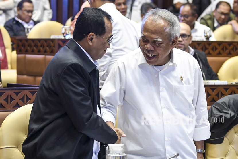Menteri PUPR Basuki Hadimuljono (kanan) berjabat tangan dengan Menteri Perhubungan Budi Karya Sumadi (kiri) sebelum mengikuti Rapat Kerja (Raker) dengan Komisi V DPR di Kompleks Parlemen, Jakarta, Senin (2/12/2019). 